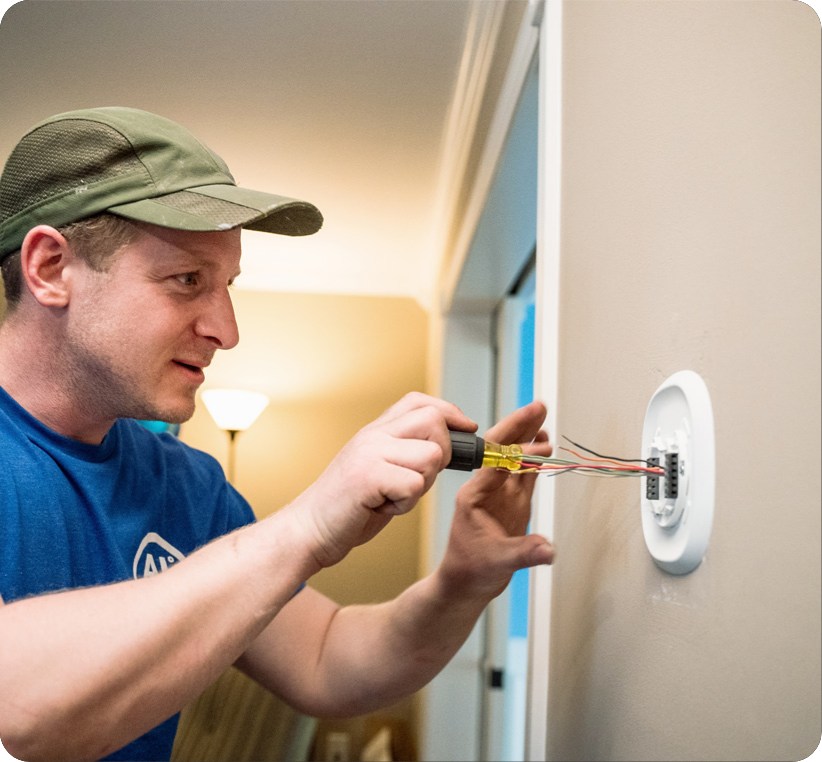 Two workers looking at an HVAC unit